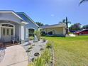 Home exterior featuring a beautifully landscaped front yard, sidewalk and view of the side yard and driveway at 827 Princeton Dr, Clermont, FL 34711