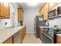 Well-lit kitchen features stainless steel appliances and light countertops at 8296 Portofino Dr # 405, Davenport, FL 33896