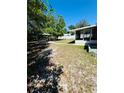Large backyard featuring lush green grass, a covered structure and potential for outdoor activities at 855 Marion Dr, Mount Dora, FL 32757