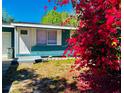 Lovely front exterior with a colorful flowering bush creating curb appeal to this cozy home at 855 Marion Dr, Mount Dora, FL 32757