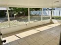 Enclosed porch offers a screened area and tile floors at 855 Marion Dr, Mount Dora, FL 32757