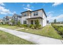 Beautiful two-story home with a well-kept lawn and lush landscaping at 8573 Lamppost Ln, Orlando, FL 32832
