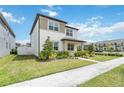 Charming two-story home featuring a well-manicured lawn and landscape at 8573 Lamppost Ln, Orlando, FL 32832