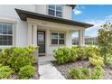 Inviting front porch with decorative pillars and manicured landscaping at 8573 Lamppost Ln, Orlando, FL 32832