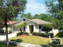 Well-kept single-story home featuring lush landscaping and a convenient two-car garage at 1053 Tourmaline Dr, Kissimmee, FL 34746