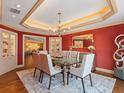 Formal dining room with glass table, display cabinets, and elegant chandelier is perfect for entertaining at 1110 W Ivanhoe Blvd # 15, Orlando, FL 32804