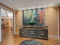 Elegant foyer with textured wallpaper, modern art, and hardwood floors exudes sophistication at 1110 W Ivanhoe Blvd # 15, Orlando, FL 32804