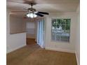 Bright living room with fan, breakfast bar, and sliding glass doors to the outside at 11574 Westwood Blvd # 1126, Orlando, FL 32821