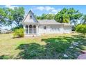 Secluded backyard featuring a well-maintained lawn and an enclosed porch area on a bright day at 1210 S Clayton St, Mount Dora, FL 32757