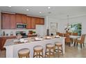 Bright kitchen featuring a center island with barstool seating and modern appliances at 1230 Sand Torch Cir, Davenport, FL 33837