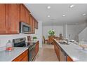Well-lit modern kitchen featuring stainless steel appliances and ample counter space at 1230 Sand Torch Cir, Davenport, FL 33837