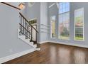 Bright living room featuring hardwood floors, a staircase, and ample natural light from large windows at 1251 Arlington Pl, Winter Park, FL 32789