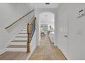 Bright entryway featuring neutral colors, tile floors, and staircase leading to upper level at 1342 Benevolent St, Maitland, FL 32751