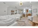 Open-concept living room featuring neutral paint, modern lighting, and seamless flow into kitchen at 1342 Benevolent St, Maitland, FL 32751