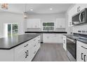 Spacious kitchen with white cabinets, stainless steel appliances, and dark countertops at 1365 Lake Dr, Casselberry, FL 32707
