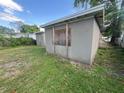 A single-story home with a gray stucco exterior and a backyard at 1515 20Th St, Orlando, FL 32805