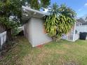 A single-story home with a gray exterior, screened in porch and side yard at 1515 20Th St, Orlando, FL 32805