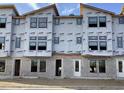 Exterior view of townhomes under construction, showcasing Typar weather-resistant barrier installation and window placements at 15489 Hamlin Park Drive, Winter Garden, FL 34787