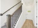 Carpeted staircase with wooden handrail leading to the upper levels of the home at 15489 Hamlin Park Drive, Winter Garden, FL 34787