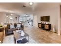 Open living space with neutral color palette, tile floors, and open kitchen concept at 1554 Dalehurst Ln, Kissimmee, FL 34744
