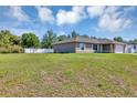 Single-story home featuring a big yard surrounded by a white fence providing a private and spacious outdoor area at 1883 Sw 160Th Pl, Ocala, FL 34473