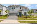 Beautiful two-story home features a well-maintained lawn, landscaped yard, and attached two-car garage at 1970 Summer Dr, Davenport, FL 33897