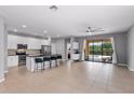 Bright, airy kitchen featuring stainless steel appliances and a breakfast bar with seating at 2142 Victoria Dr, Davenport, FL 33837