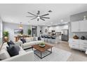 Open-concept living space with a dining area and a modern kitchen with a breakfast bar at 2142 Victoria Dr, Davenport, FL 33837