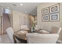Cozy dining area featuring a round table with seating for four, complemented by stylish decor and stairway at 2211 Wadeview Loop, St Cloud, FL 34769