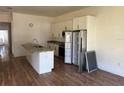 Updated kitchen with island, stainless appliances, granite countertops, and ample cabinet space at 232 S Clara Ave, Deland, FL 32720