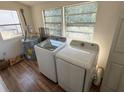 Functional laundry room with modern washer, dryer, and water heater setup at 232 S Clara Ave, Deland, FL 32720