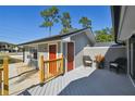 Side deck view of gray home with outdoor seating area at 2613 Howland Blvd, Deltona, FL 32738