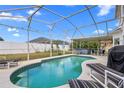 A private screened-in pool with lounge chairs and outdoor dining area for relaxation at 2837 Drifting Lilly Loop, Kissimmee, FL 34747