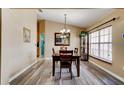 Cozy dining area with wood floors, chandelier, and a large window at 2951 E Waco Dr, Deltona, FL 32738