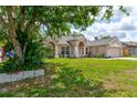 Inviting single-story home with a lush front lawn and mature landscaping at 2951 E Waco Dr, Deltona, FL 32738