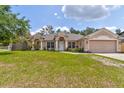 Lovely single-story home with a manicured lawn and an attached two-car garage at 2951 E Waco Dr, Deltona, FL 32738