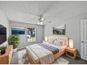 Cozy bedroom featuring a comfortable bed, plush rug, and serene natural light from a window at 3115 Whispering Trails St, Winter Haven, FL 33884
