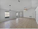 Open-concept living room with tile flooring, neutral paint, and ample space for various furniture arrangements at 3115 Whispering Trails St, Winter Haven, FL 33884