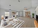 Bright living room with tile flooring, modern white furniture, and charming built-in shelving units at 3115 Whispering Trails St, Winter Haven, FL 33884