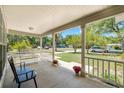 Inviting front porch with comfortable seating and flower pots, offering a relaxing outdoor space at 441 S Blue Lake Ave, Deland, FL 32724