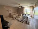 Relaxing living room featuring a plush sectional sofa, dining table, and ceiling fan at 510 Cranes Way # 105, Altamonte Springs, FL 32701