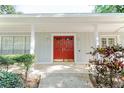 Inviting front entrance of home featuring a red double door and manicured landscaping at 604 Blue Lake Dr, Longwood, FL 32779