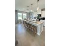 Modern kitchen features a large island with pendant lighting and seating at 6450 Horseshoe Lane Way, St Cloud, FL 34773