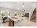 Open floor plan showcases a large kitchen island with seating and seamless transition to the living area at 660 Egret Place Dr, Winter Garden, FL 34787