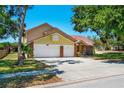 Charming two-story home features a brick-accented facade and a spacious two-car garage at 6630 Abeydon Ct, Orlando, FL 32818