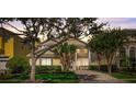 Inviting exterior of a well-maintained home with lush landscaping and a stately entrance at 7388 Gathering Ct, Reunion, FL 34747