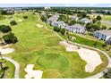 Scenic view of the green golf course surrounding beautiful blue and white condo building at 7649 Heritage Crossing Way # 302, Reunion, FL 34747