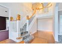 Elegant foyer featuring a staircase with white railings and beautiful hardwood floors at 910 Cypress Ave, St Cloud, FL 34769