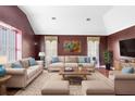 Cozy living room with plush seating, elegant decor, and a vaulted ceiling at 910 Cypress Ave, St Cloud, FL 34769
