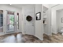 Home foyer featuring tile flooring, white walls, closet and front door with glass panels at 9349 Sweet Maple Ave, Orlando, FL 32832